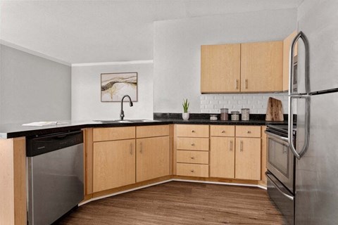 a kitchen with black countertops and wooden cabinets